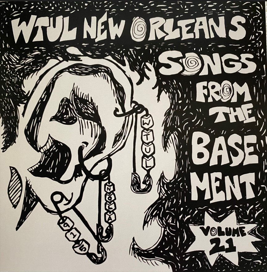 A close-up of a person's ear with multiple piercings. Text reads "WTUL New Orleans Songs From The Basement Volume 21."