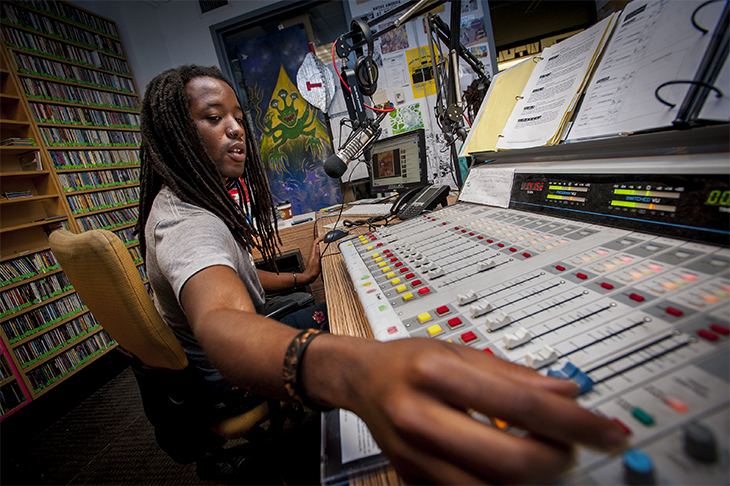 WTUL DJ monitors the board during his weekly show